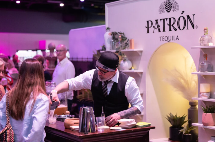 A photo of a bartender/server at the Patron Tequila booth at the Wine & Spirit Festival.