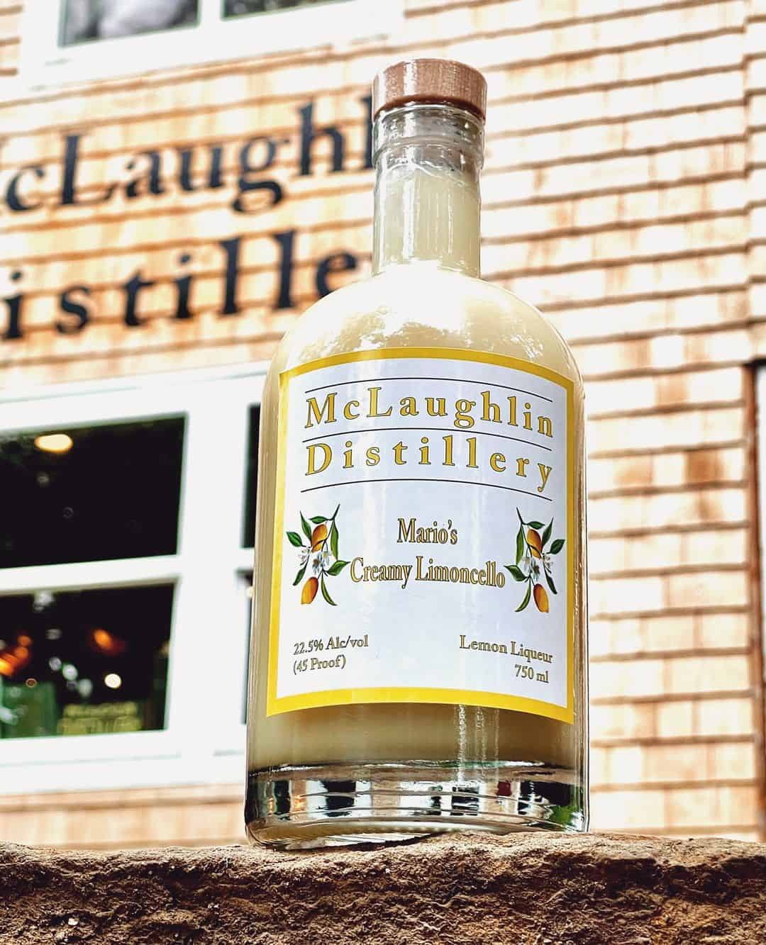 A photo of Mario's Creamy Limoncello in front of the McLaughlin Distillery.