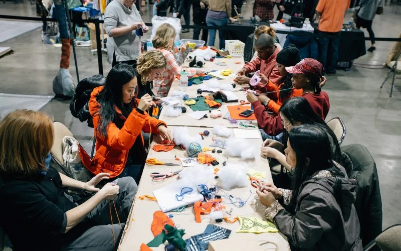 A photo of people making the Make-and-Take craft at a previous Handmade Arcade event.