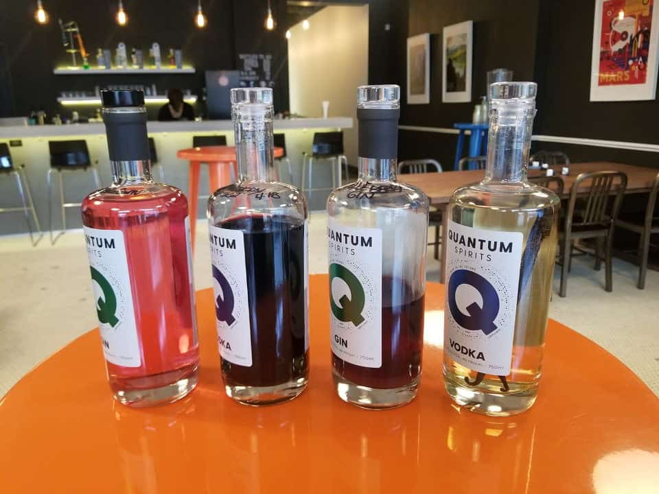 A photo of 4 Quantum Spirits bottles of vodka and gin.