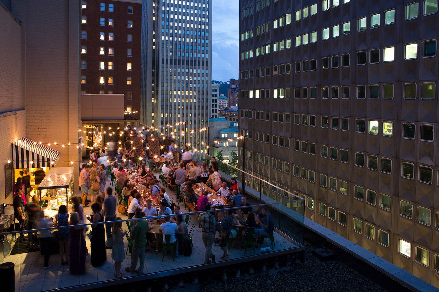 A photo of people dining and drinking at the Biergarten rooftop bar.