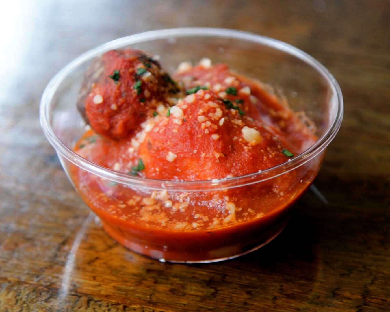 A photo of a mini meatball cup sample at Osteria.