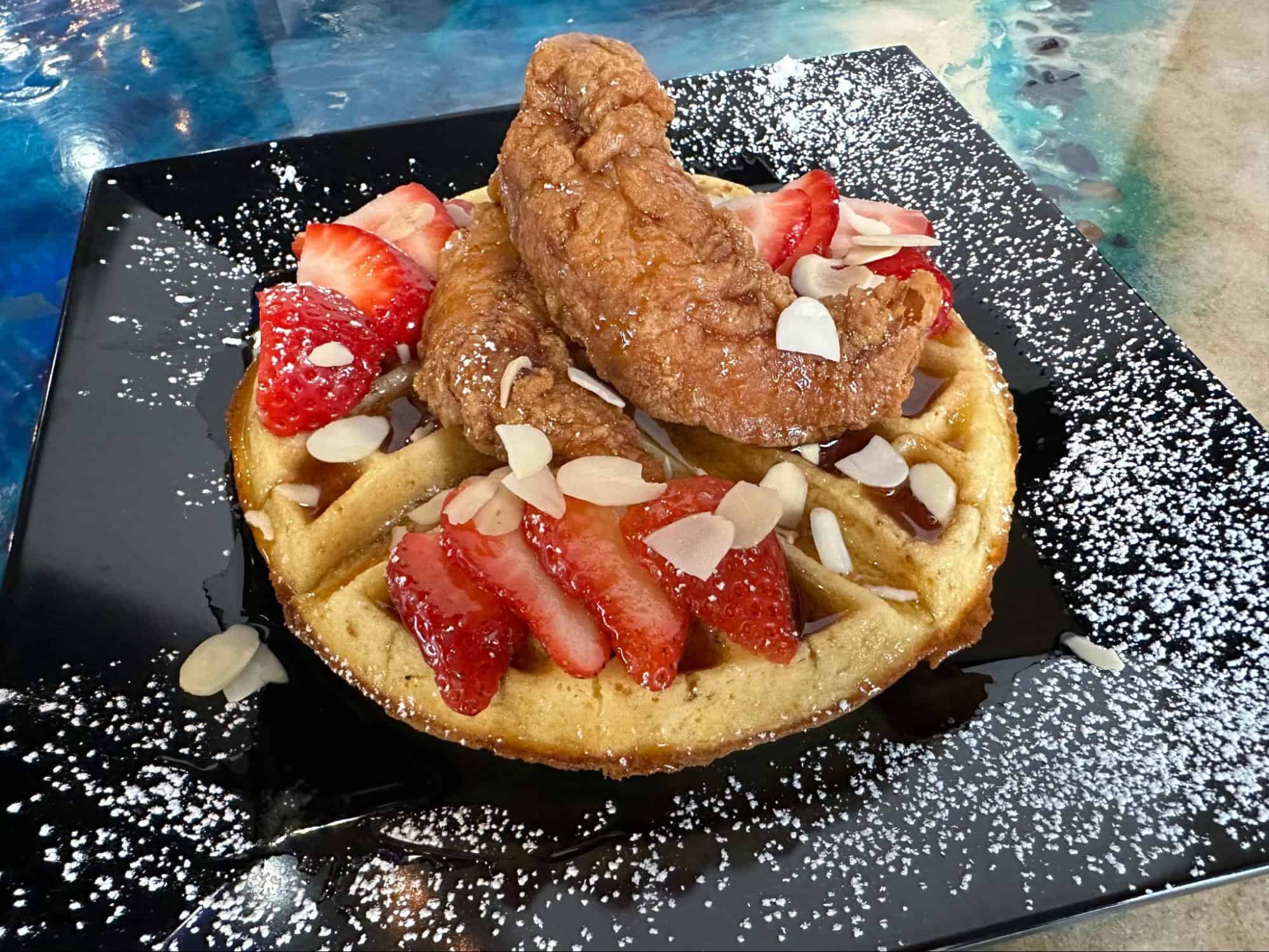 Chicken and strawberries on top of a waffle at Liberty Chick 'n' Fish.