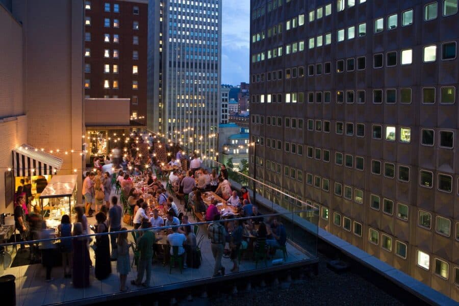 A photo of people dining and drinking on the rooftop at Biergarten at the Hotel Monaco in Pittsburgh.