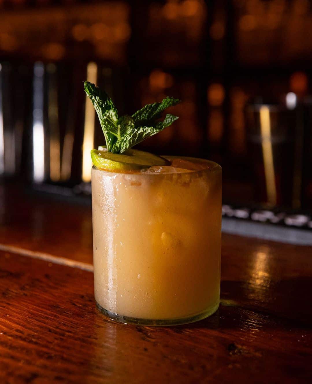 A photo of a cocktail with lime and mint at tako.