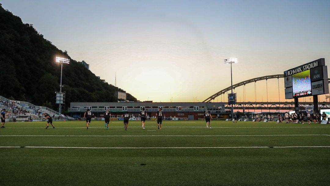 A photo of the Thunderbirds playing at Highmark Stadium under a sunset.