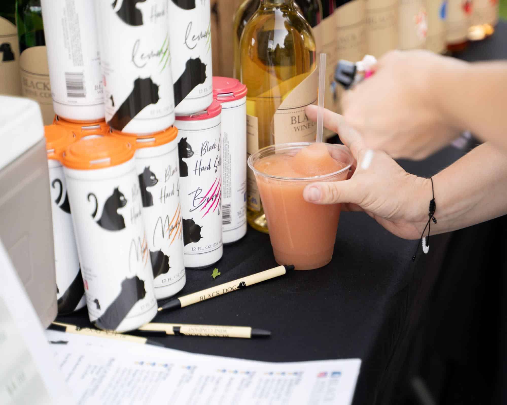 A display of Black Dog wine products and a frozen wine slushie at Moon Market & Music.