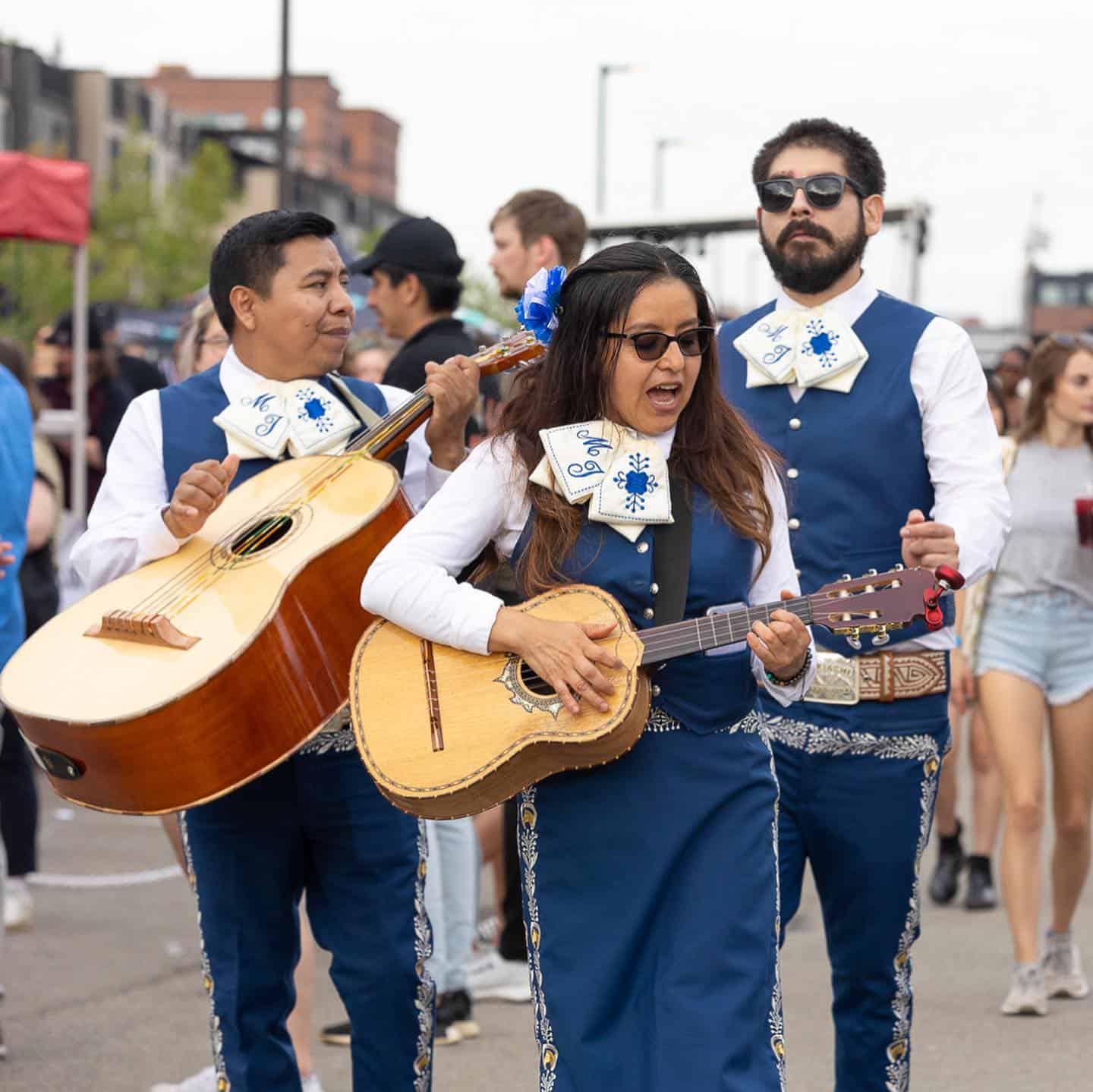 A photo of music performers in traditional clothing playing at the Pittsburgh Taco Festival.