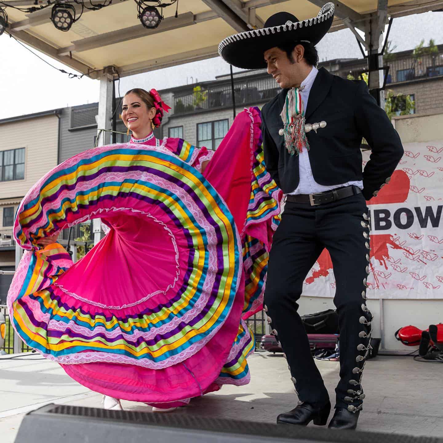 A photo of dancers in traditional clothing performing a salsa dance at the Pittsburgh Taco Festival.