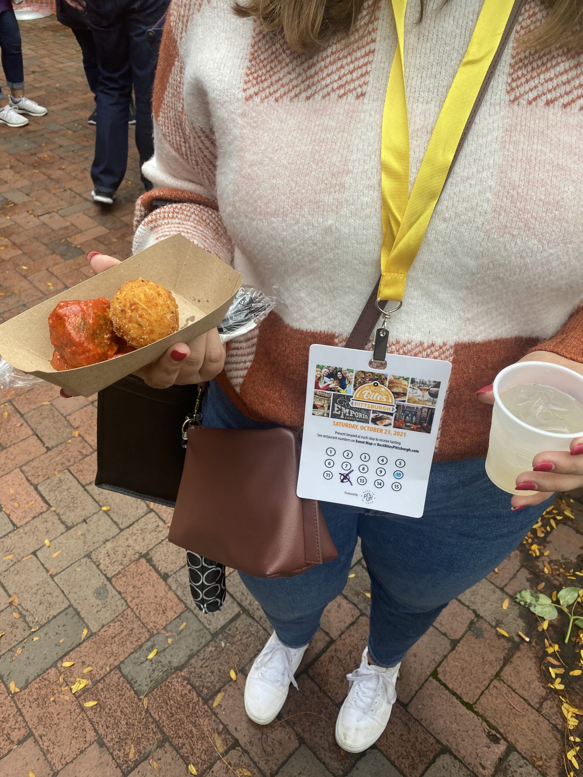 A photo of a person with a Best Bites lanyard, a food tasting, and a drink tasting.