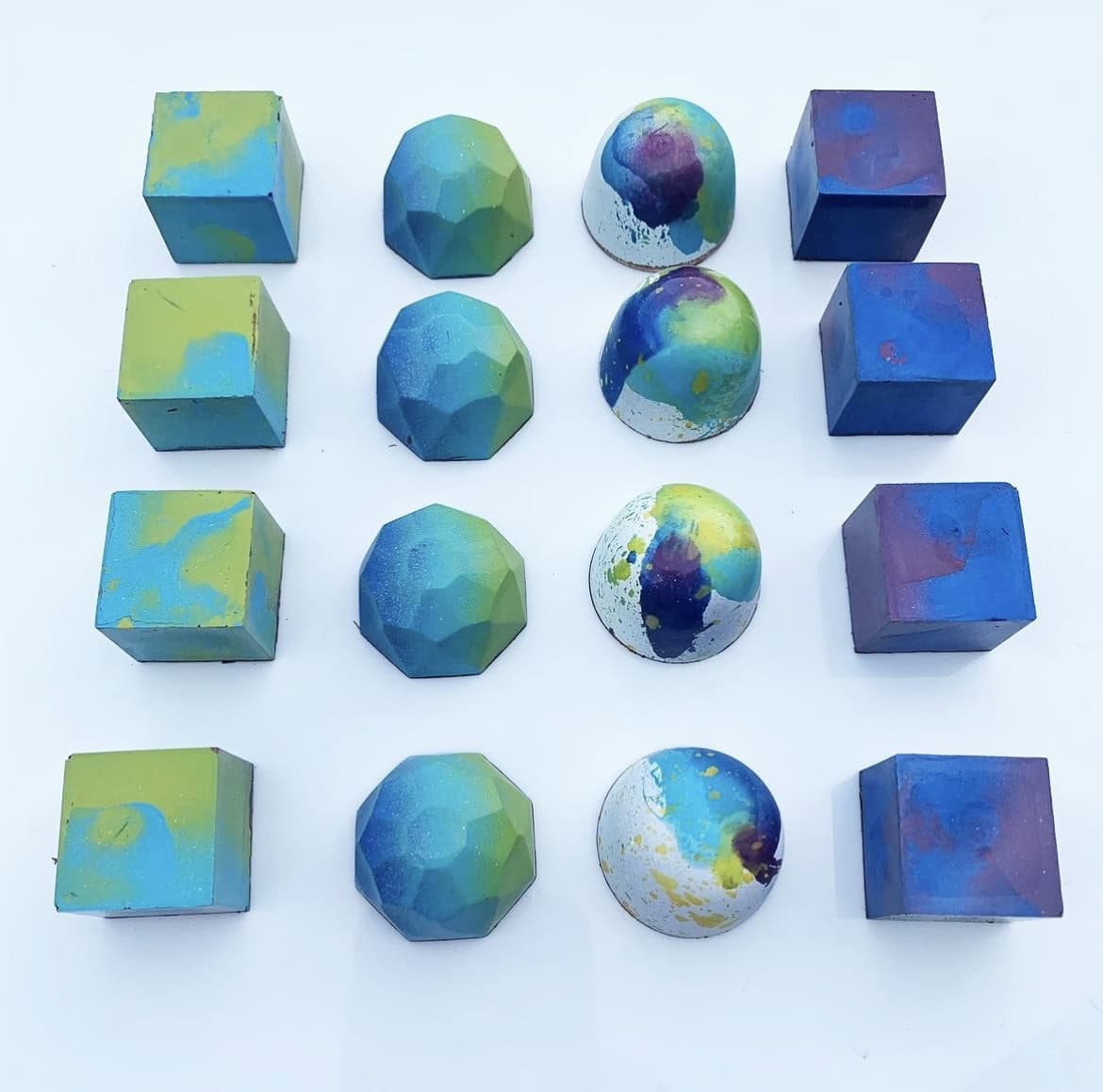 A photo of purple, blue, and green chocolates of different fancy shapes from A519 Chocolate.