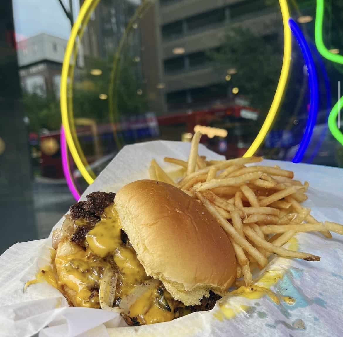 A photo of a smash burger and shoestring fries at Moonlit Burgers.