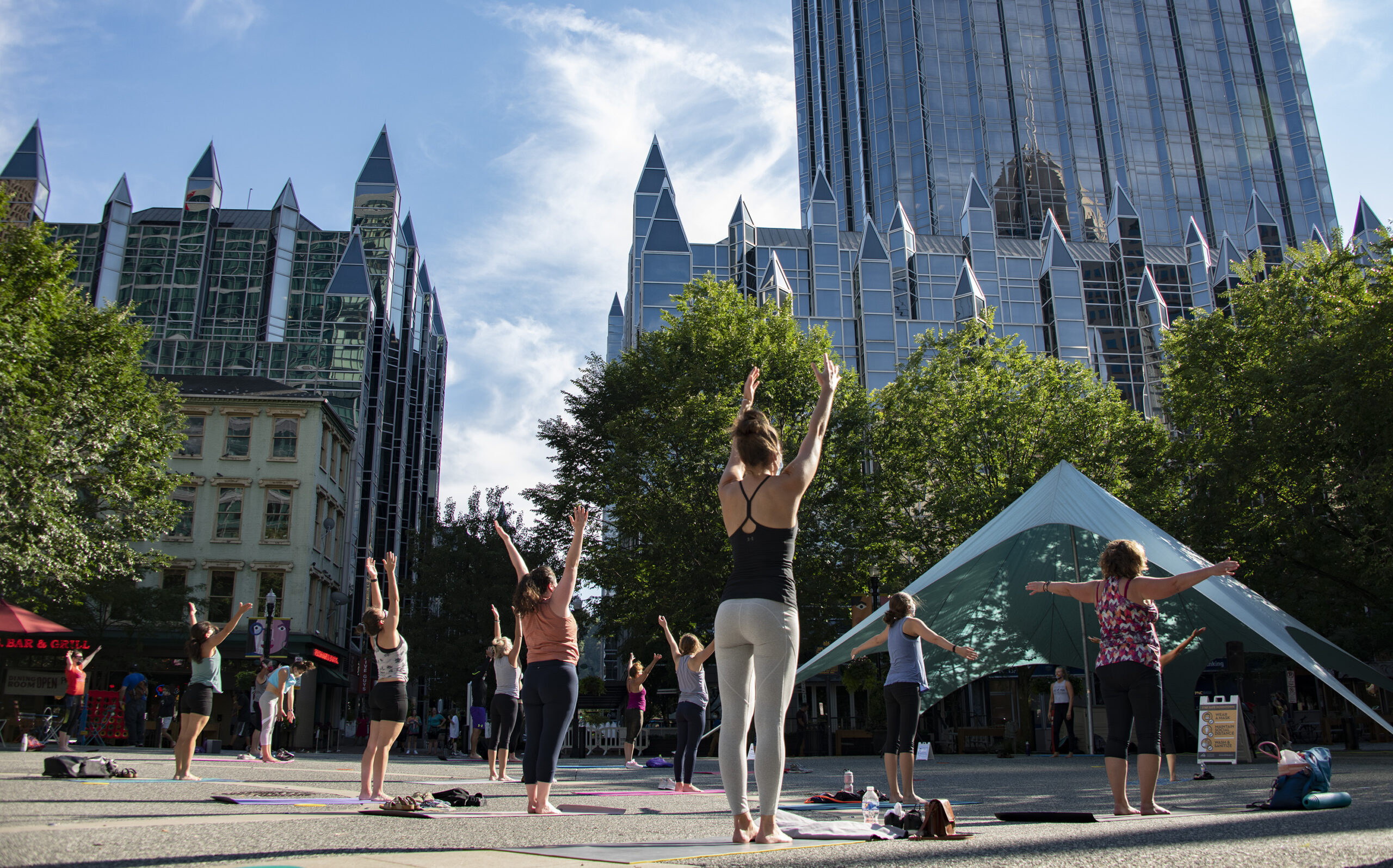 A photo of people practicing yoga in Market Square downtown.