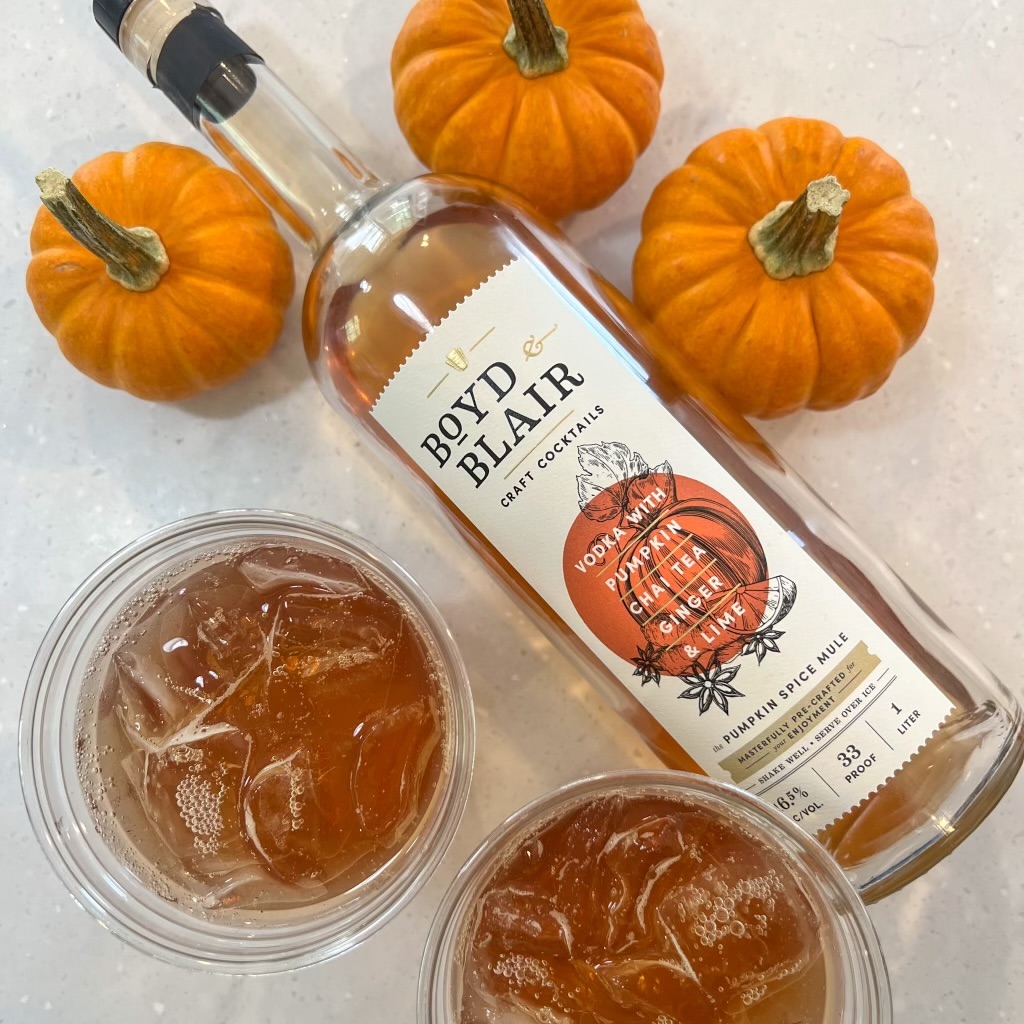 A photo of a bottle of Boyd & Blair potato vodka and mixed drinks with pumpkins. Boyd & Blair which will be at the Great Yinzer Tailgate on November 4th, 2023.