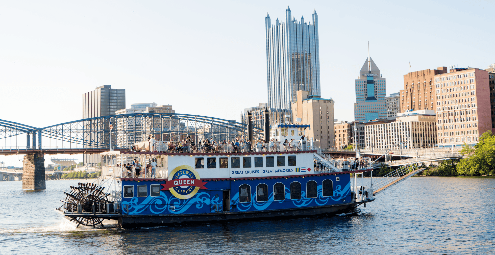 A photo of the Gateway Clipper on the river with downtown Pittsburgh in the background.