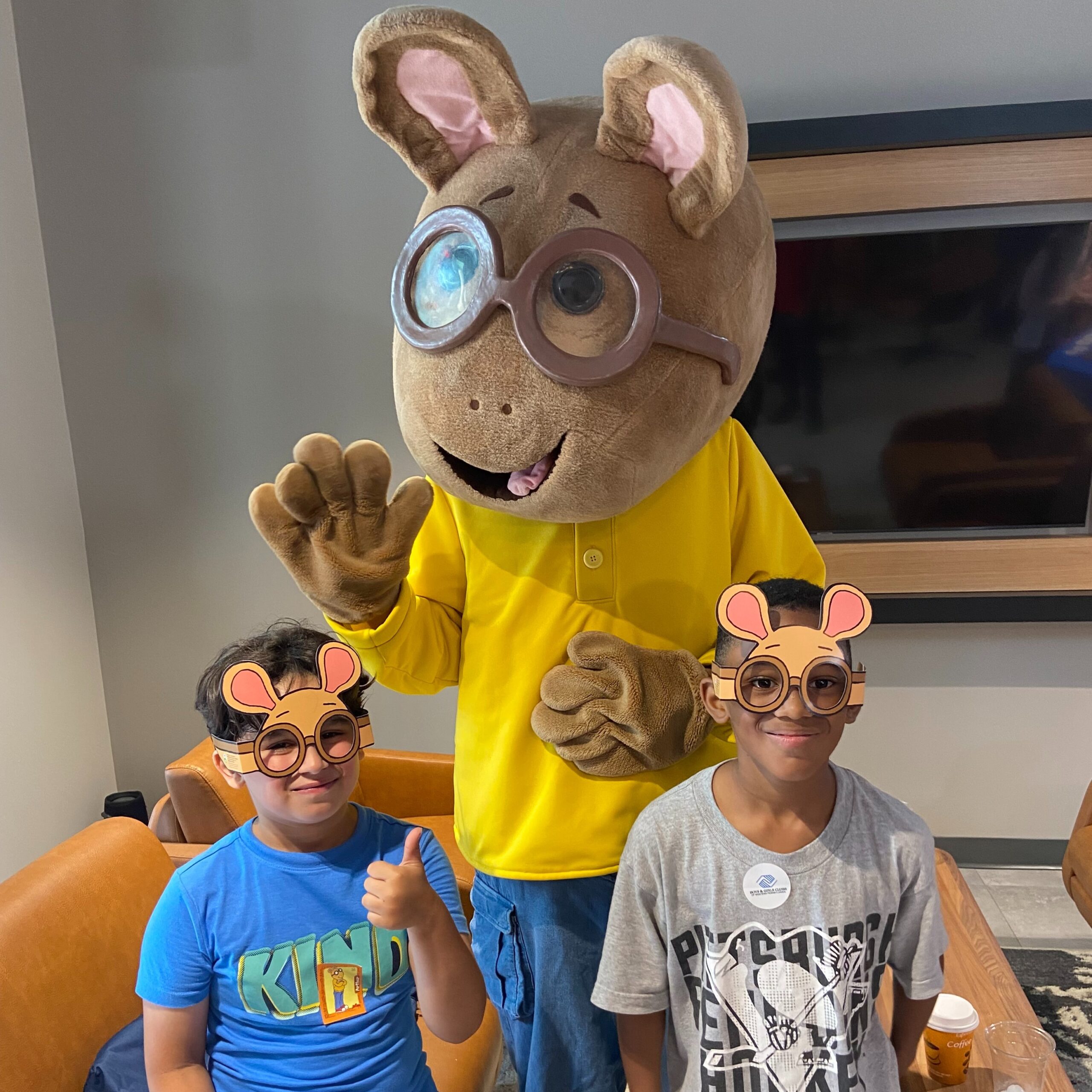 A photo of the Arthur mascot posing with two children. Arthur will be at the Great Yinzer Tailgate on November 4th, 2023.