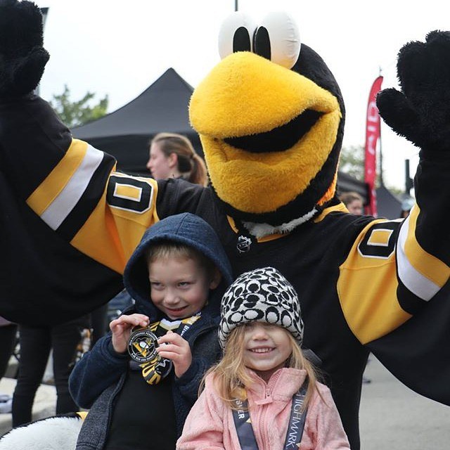 A photo of kids with Iceburgh, the Pittsburgh Penguins' mascot, who will be at the Great Yinzer Tailgate on November 4th, 2023.
