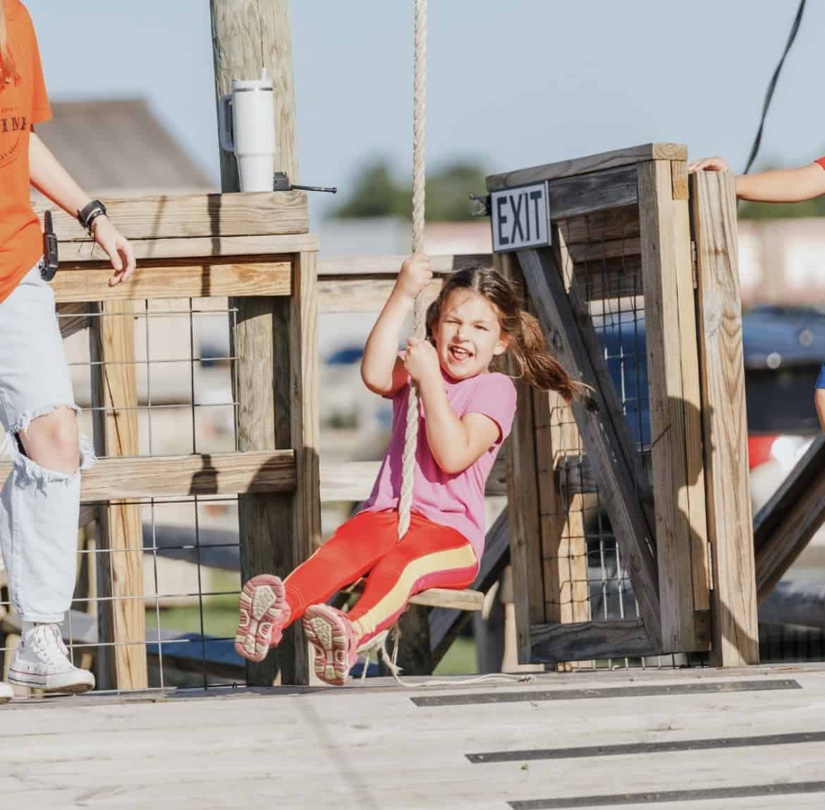 A photo of a child on a rope swing at Irons Mill Farmstead.
