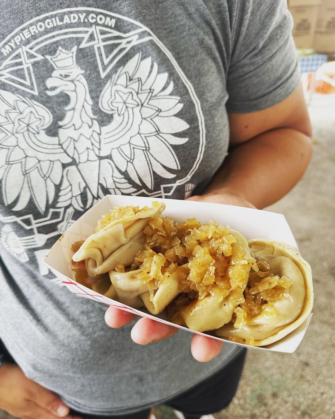 A photo of pierogis with onions on top from The Pierogi Lady, which will be at the Great Yinzer Tailgate on November 4th, 2023.