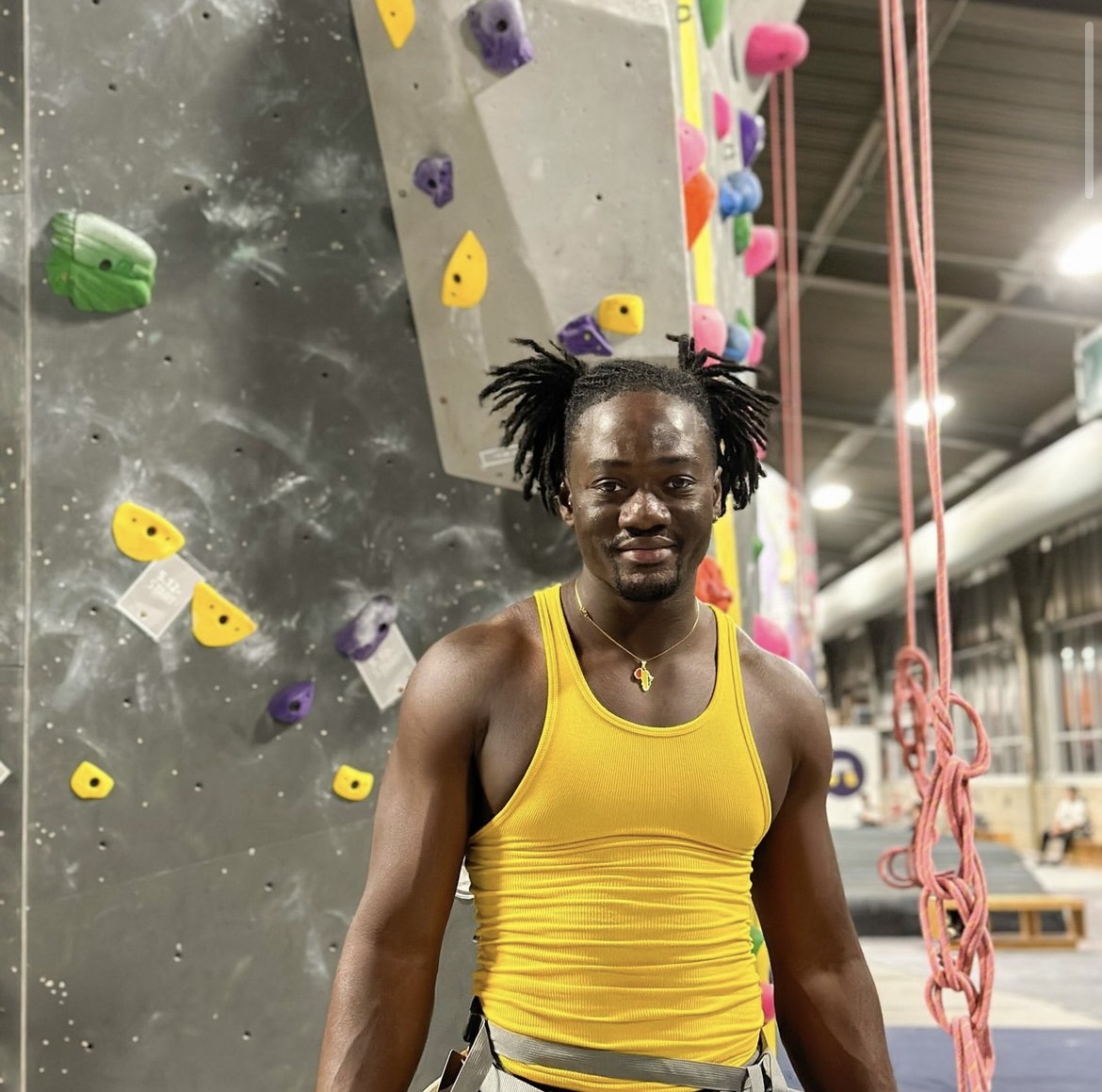A person standing in front of the rock climbing walls at ASCEND, a great sober activity.