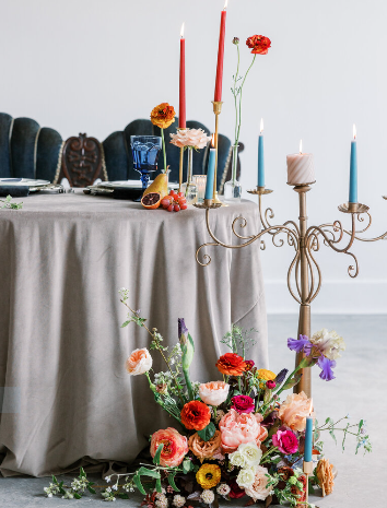 A photo of flowers and candlesticks set at a sweetheart table at Franklin on Penn.