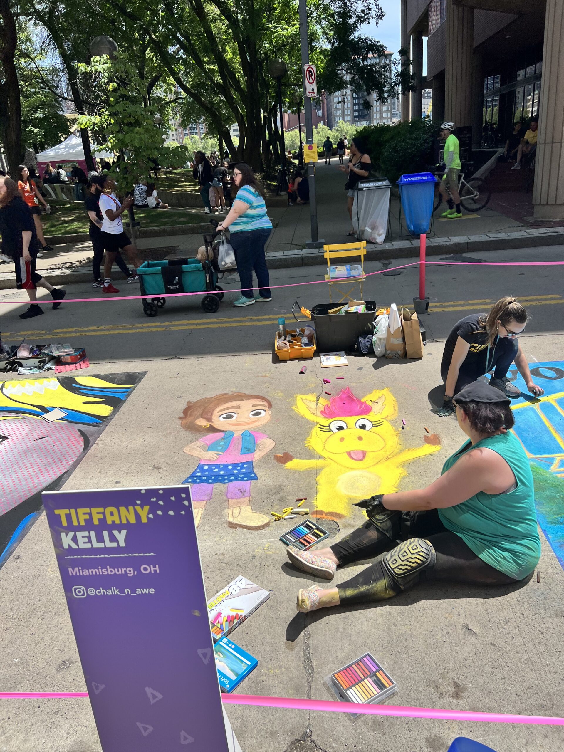 A photo of artists working on chalk art at Riverlife Chalk Fest.
