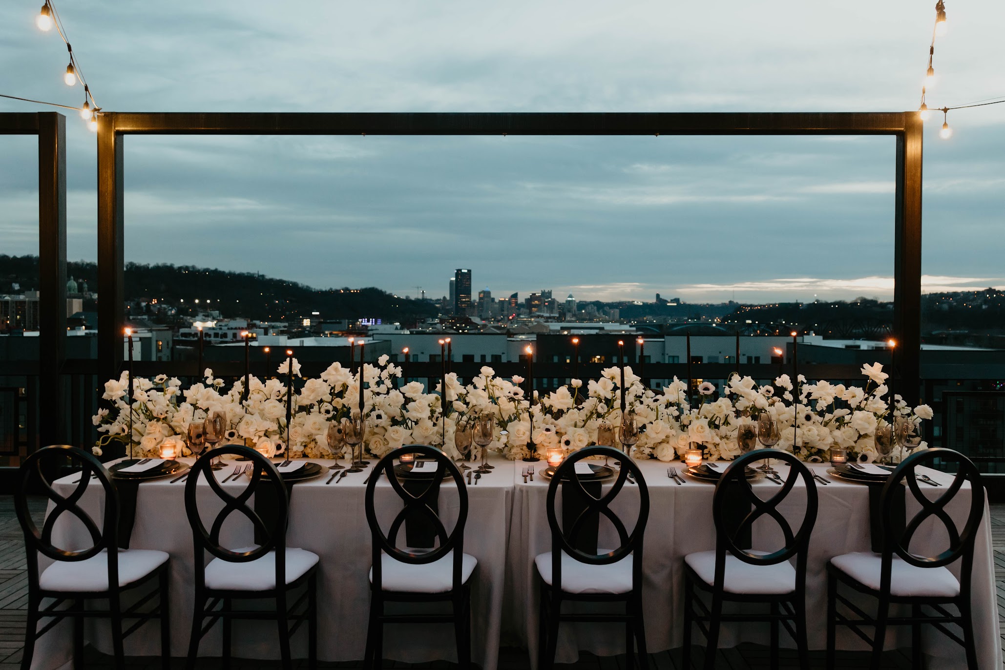 A photo of chairs and tables set up at a wedding, facing downtown Pittsburgh.