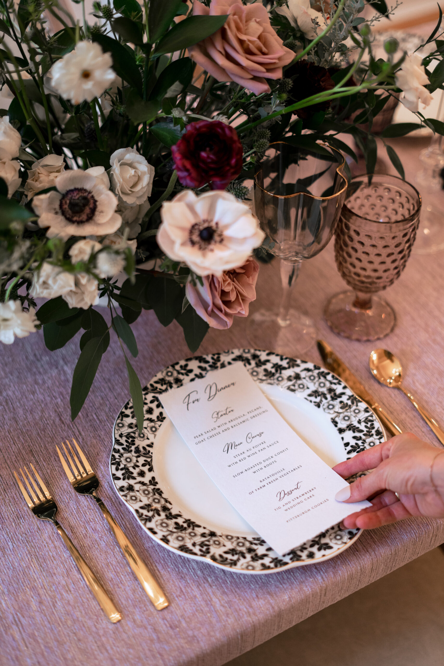 A photo of a dinner setting and menu at a wedding.