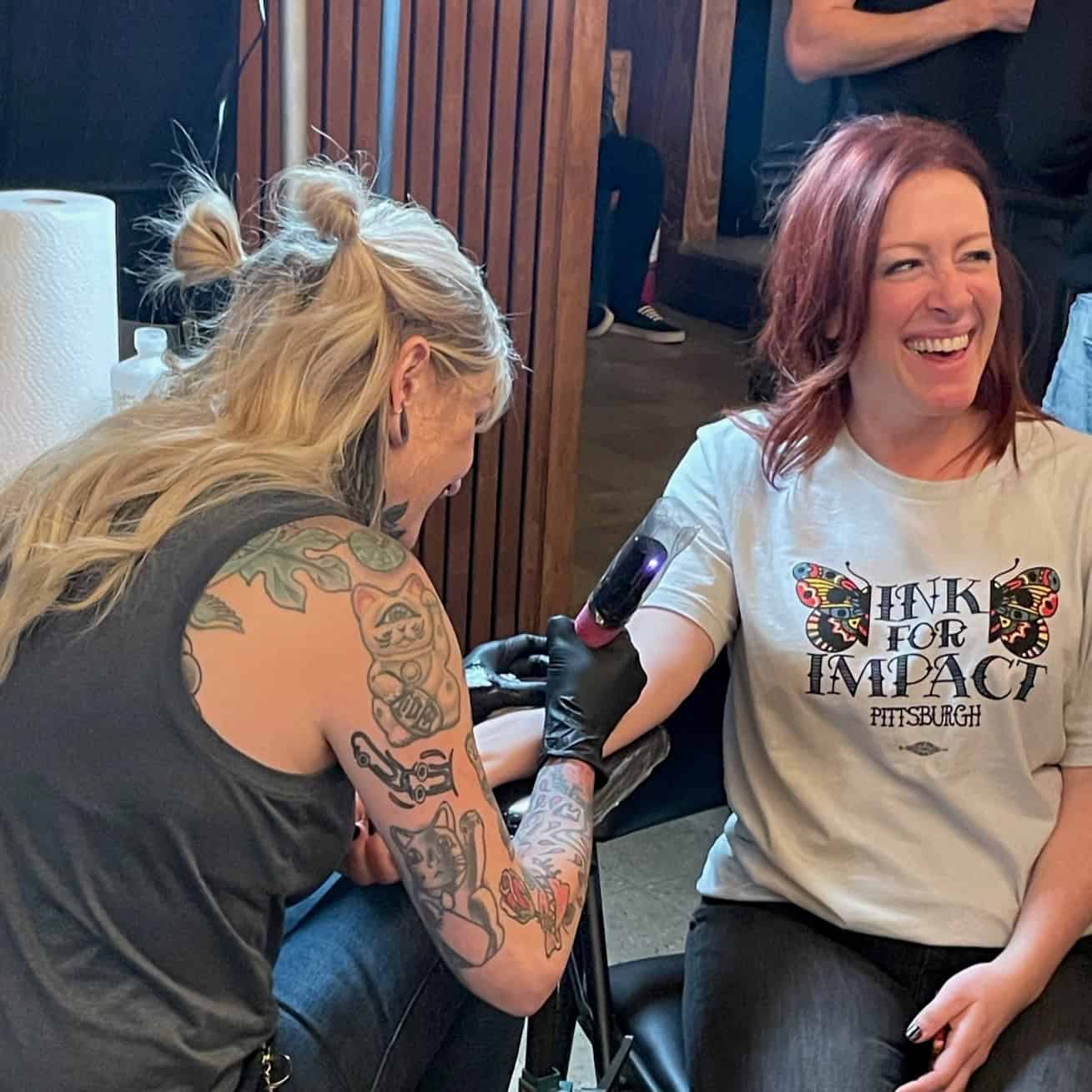 A photo of a person getting an arm tattoo at Ink for Impact in 2023.
