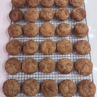 A photo of snickerdoodle cookies on a baking cooling rack.
