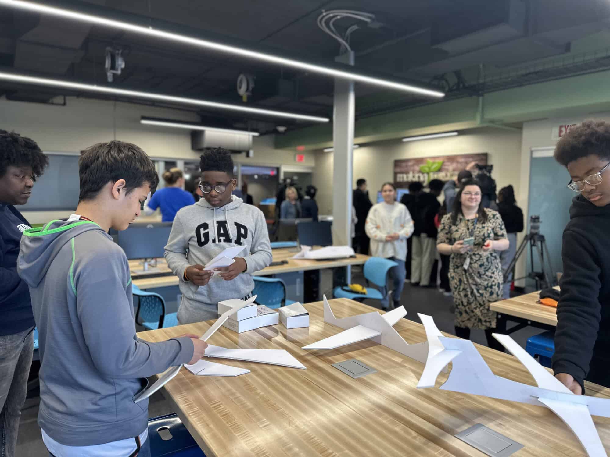A photo of children working with 3D design and fabrication in the Fab Lab.