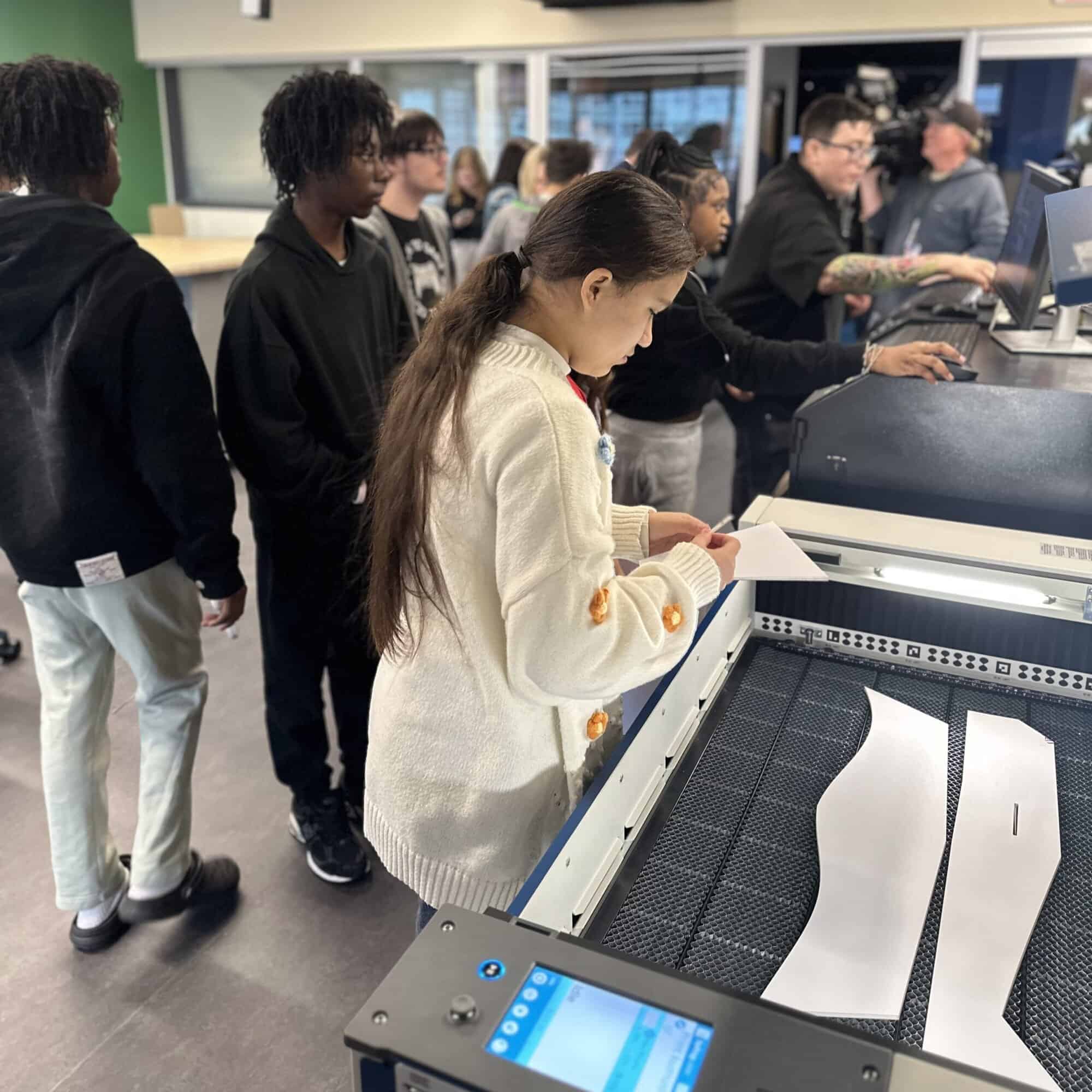 A photo of children working with machines in the Fab Lab.
