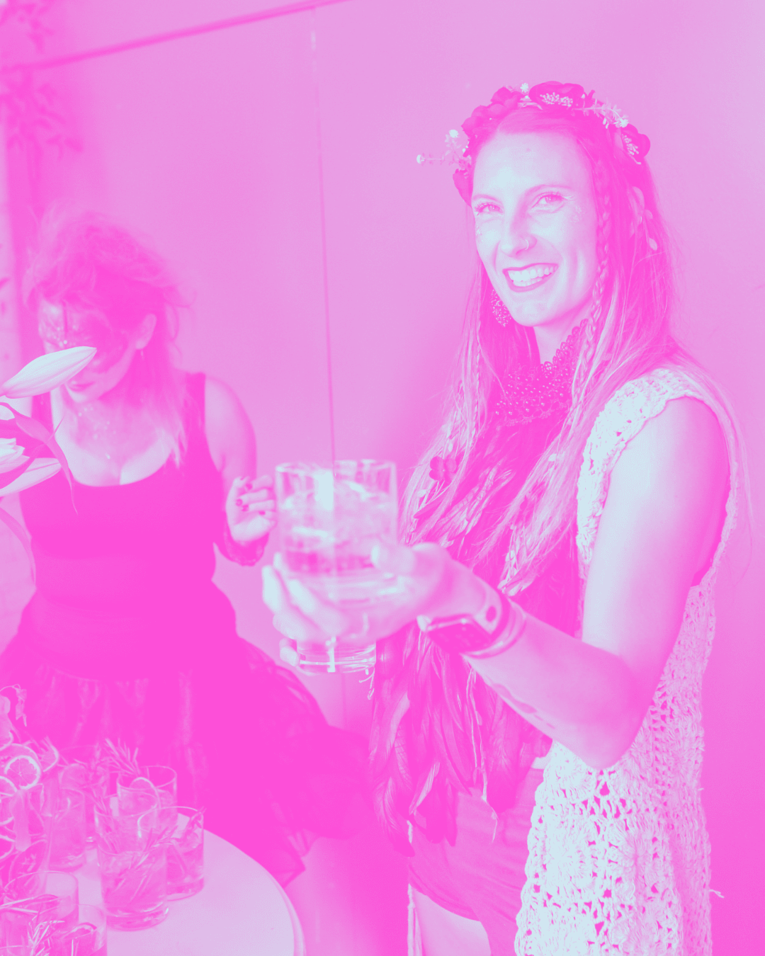 A photo with a bright pink filter of a woman holding a drink.