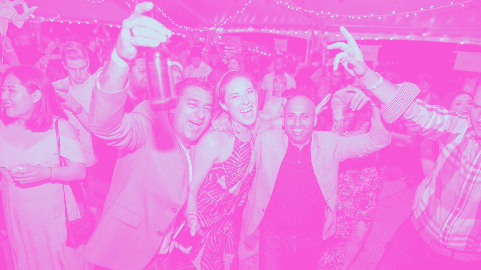 A photo with a bright pink filter of people dancing and singing.
