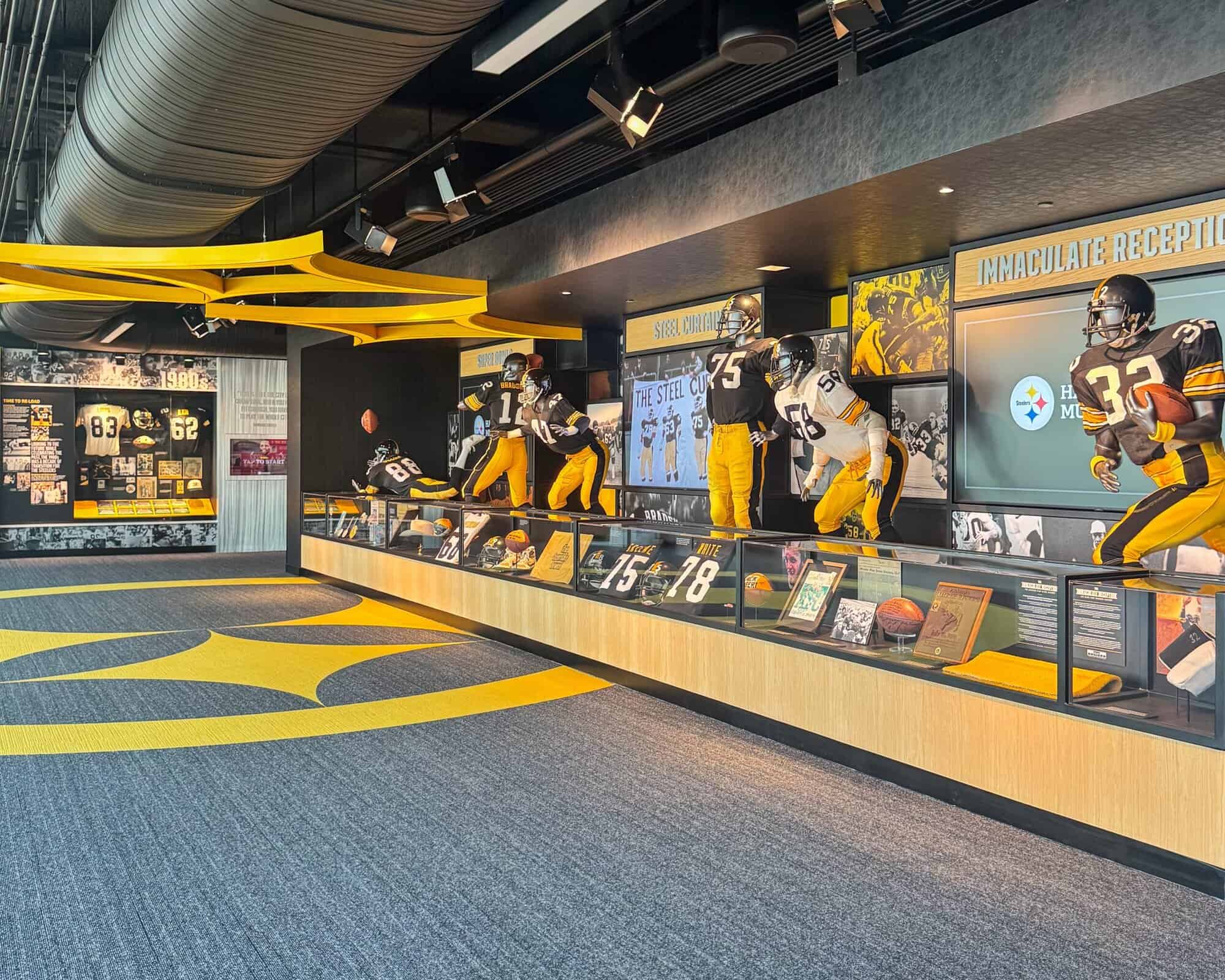 A photo of uniforms, plays, photos, and more on display at the Hall of Honor.