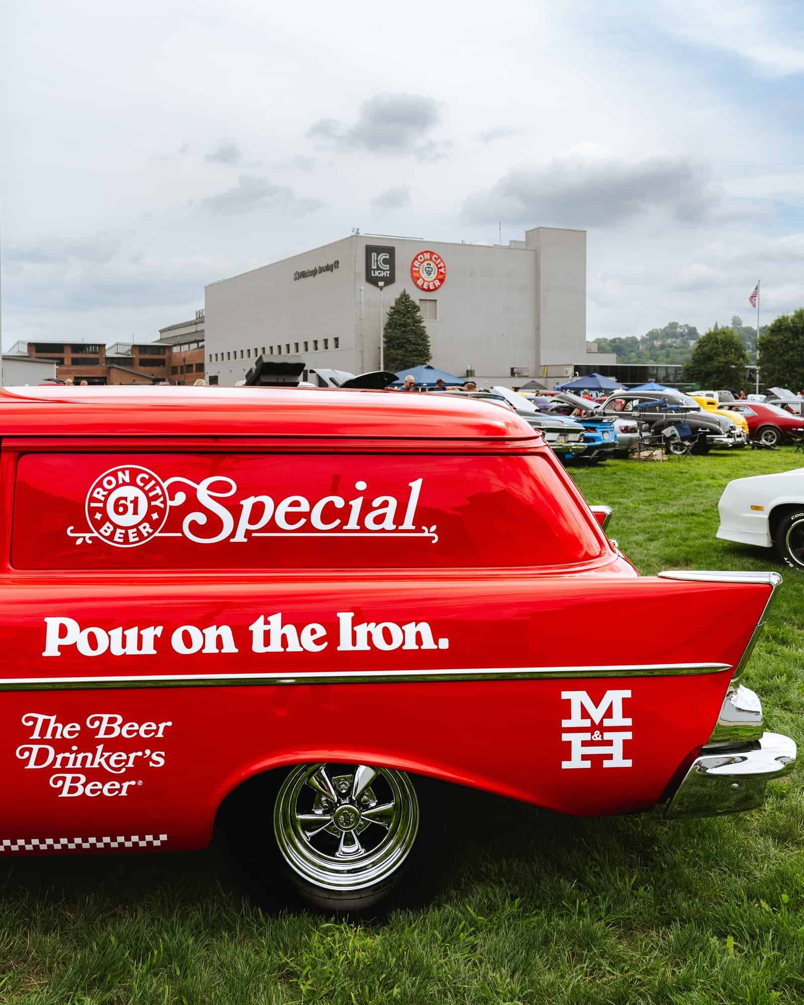 A photo of a red car at Pittsburgh Brewing Co. with a special Iron City Beer design.