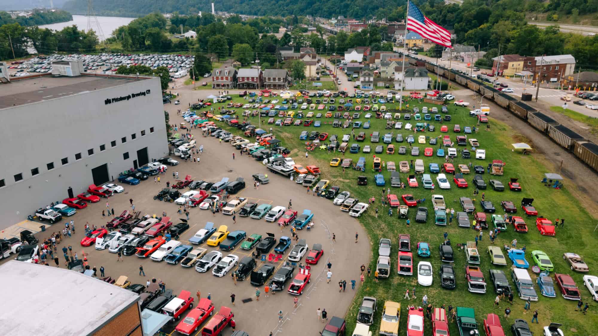 An overhead photo of classic cars lined up outside of Pittsburgh Brewing Co.