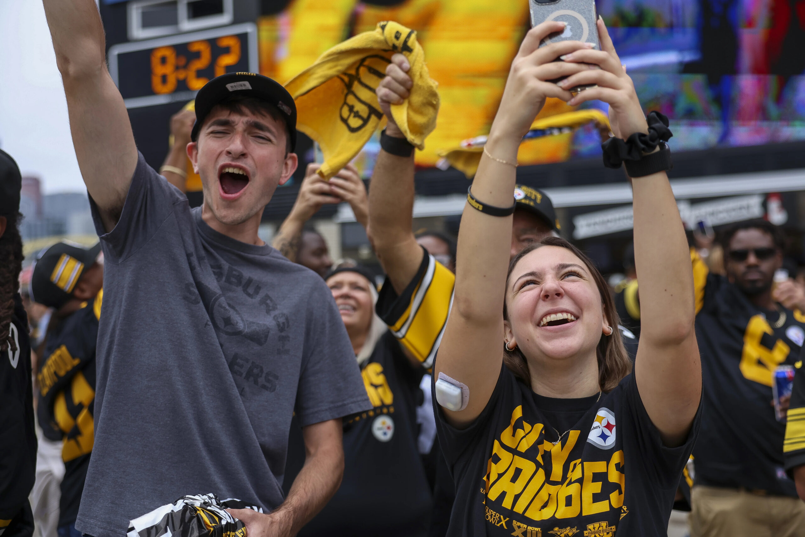 A photo of college students cheering at a Steelers game.