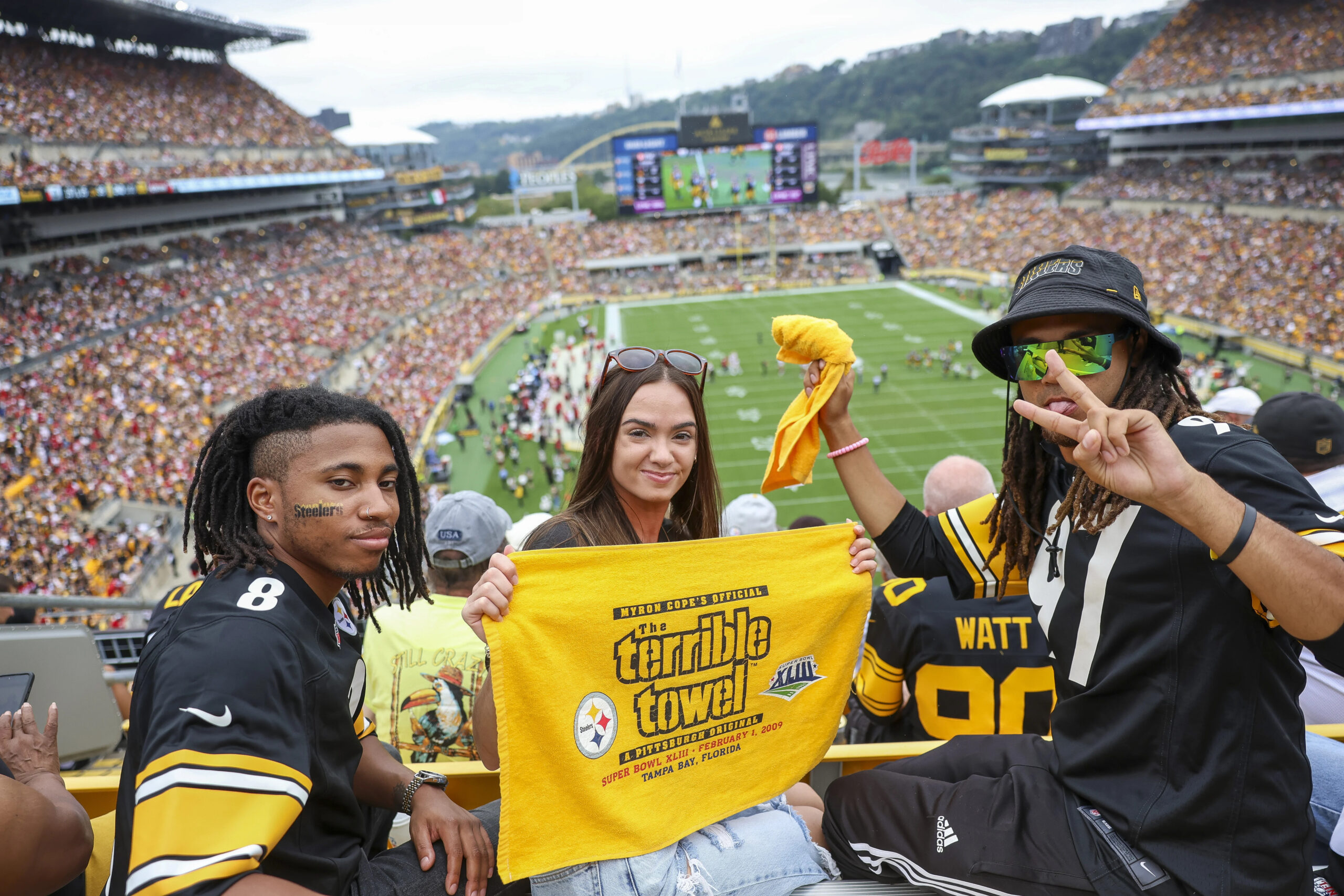 A photo of college students posing at a Steelers game.