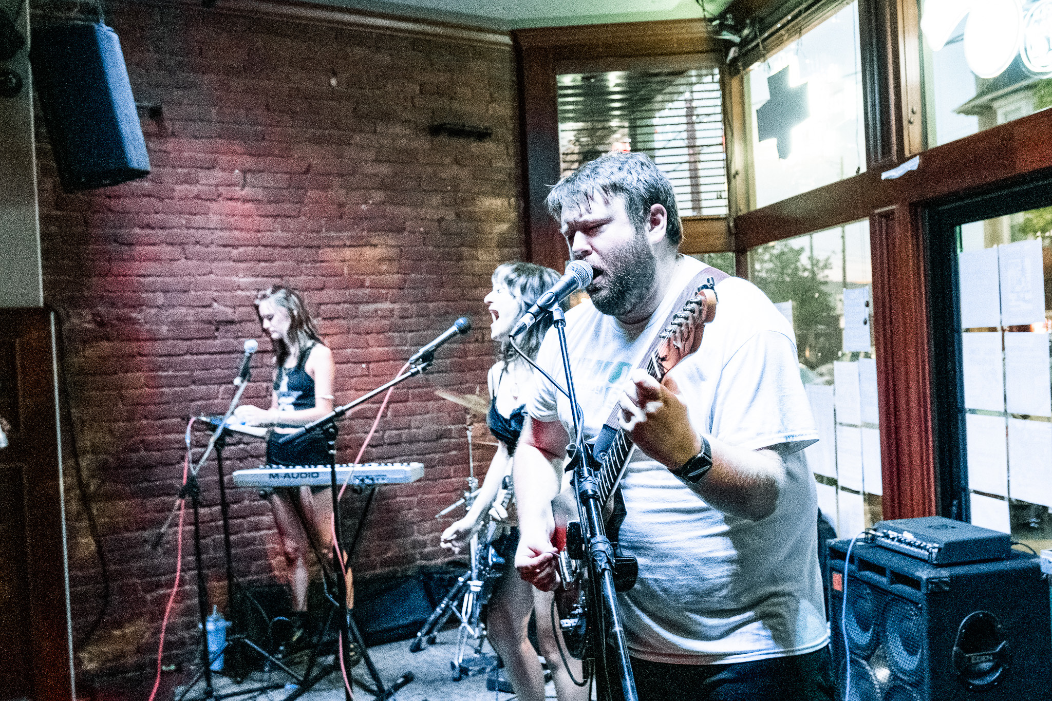 A photo of the members of Eyewash performing on stage.