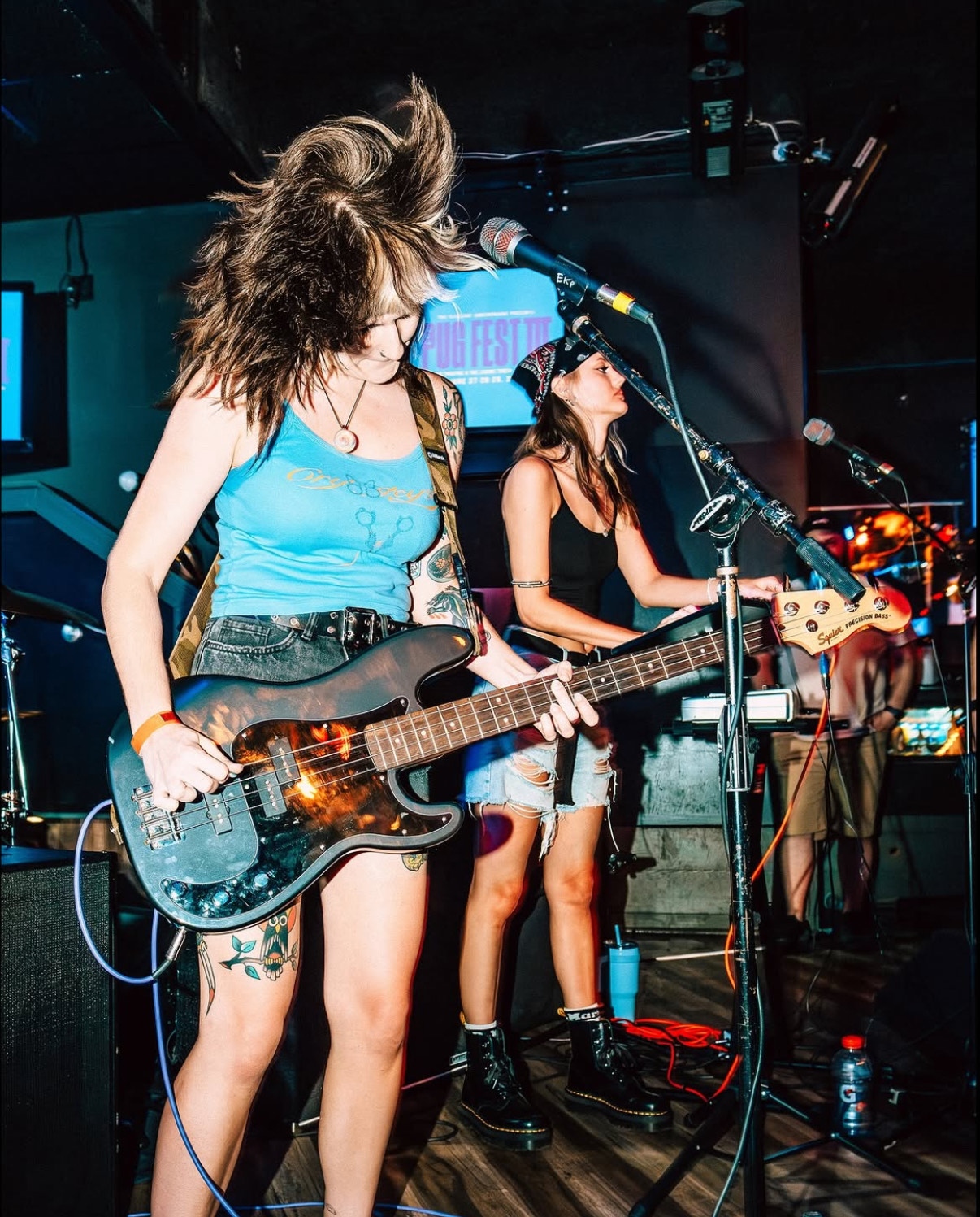 A photo of two members of Eyewash performing on stage.
