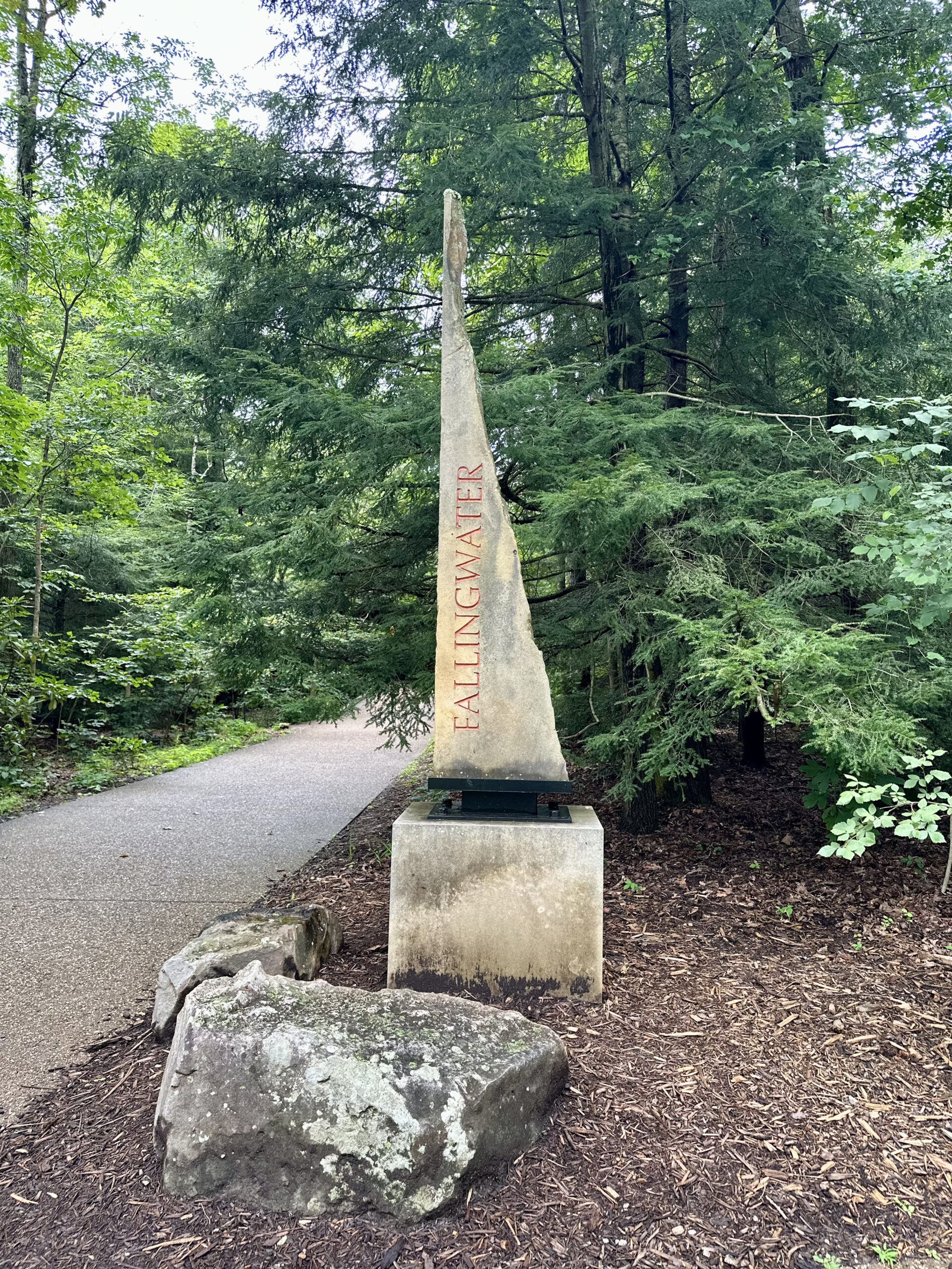 A photo of a sign for Fallingwater printed on a natural rock.