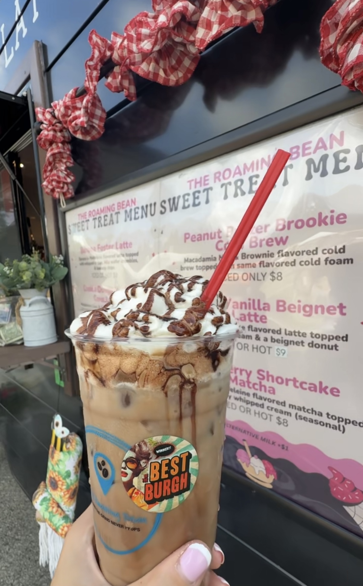 A photo of a Roaming Bean drink topped with chocolate.
