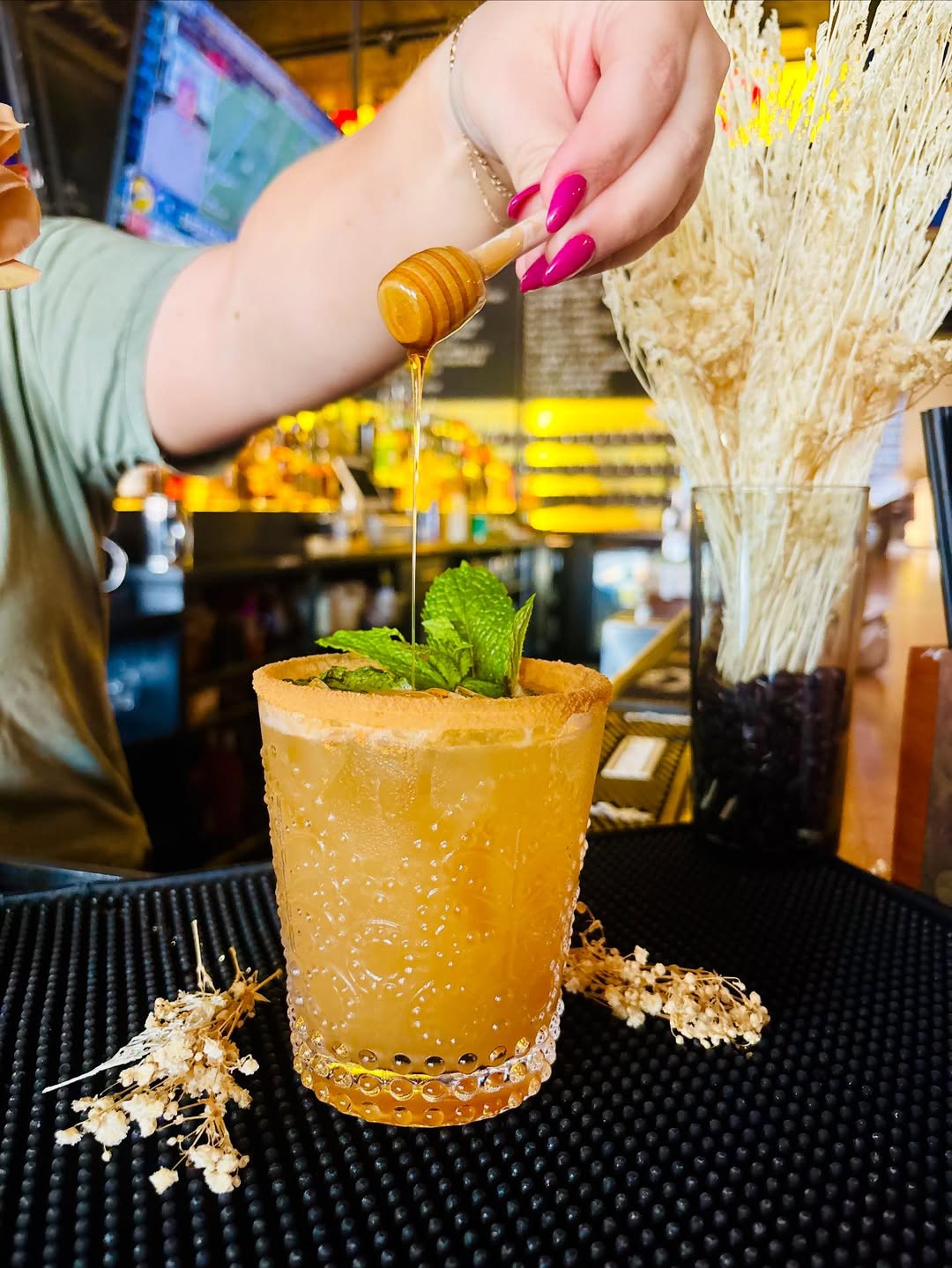 A photo of the Spiced Pear Margarita topped with honey from The Urban Tap, available around Thanksgiving.