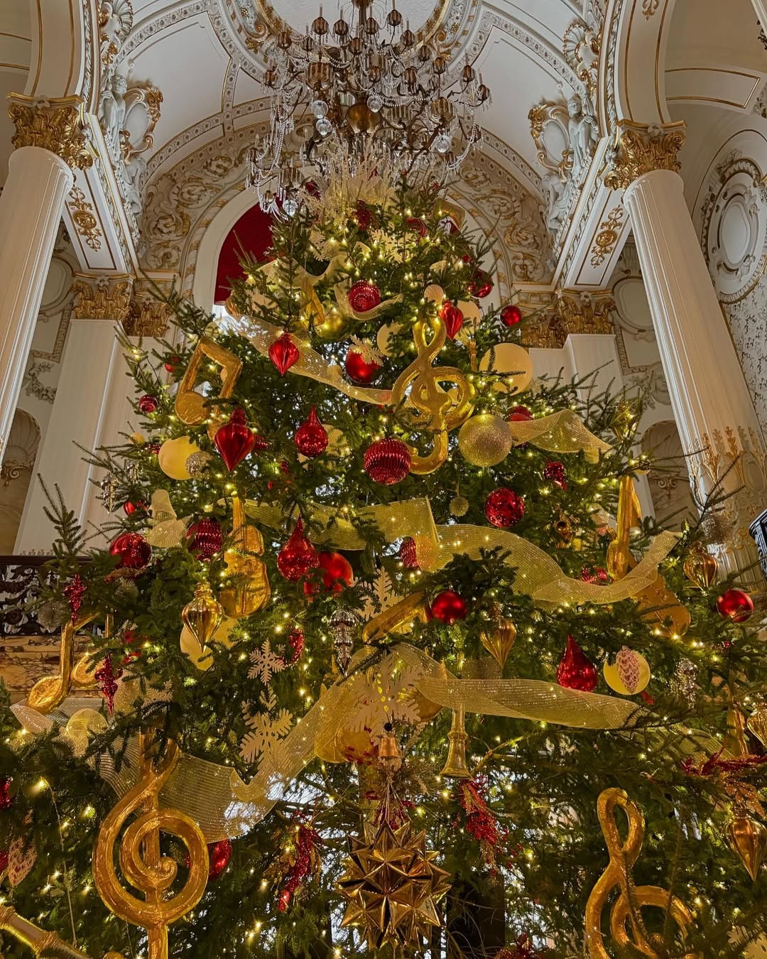 A photo of a Christmas tree decorated with red and gold at Heinz Hall.