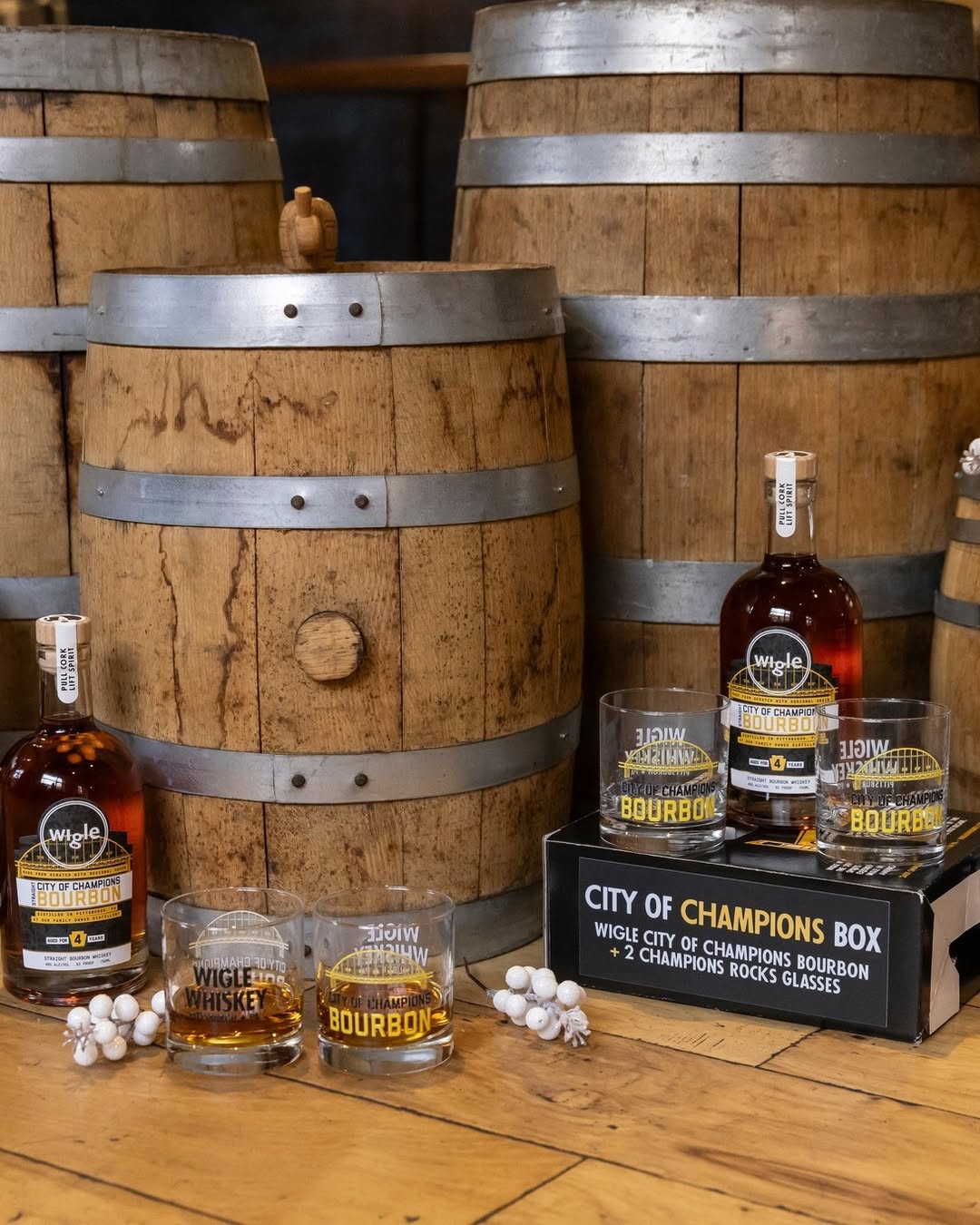 A photo of the Wigle Whiskey City of Champions box with bourbon and glasses.